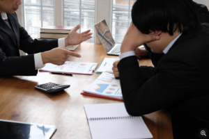 Two business professionals reviewing marketing performance reports during a strategy meeting